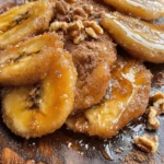 Imagine biting into a slice of warm, golden banana, its natural sweetness enhanced by a rich, buttery sauce infused with the comforting warmth of cinnamon. Fried Bananas with Cinnamon Butter Sauce is not just a dessert; it is an experience that combines simplicity with indulgence. This dish is incredibly easy to prepare, making it an ideal choice for anyone looking to impress guests or indulge in a sweet treat after a long day. The recipe beautifully marries the soft texture of ripe bananas with a luscious sauce that elevates the dish from a simple snack to a luxurious dessert.